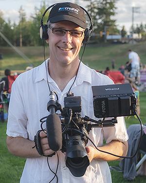 A man holding camera equipment.