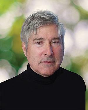 A man with grey hair wearing a black turtleneck shirt. 